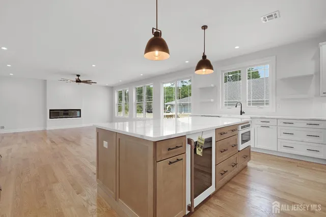 a bathroom with a granite countertop sink a toilet and a mirror