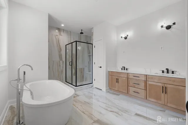 an empty room with wooden floor ceiling fan and windows