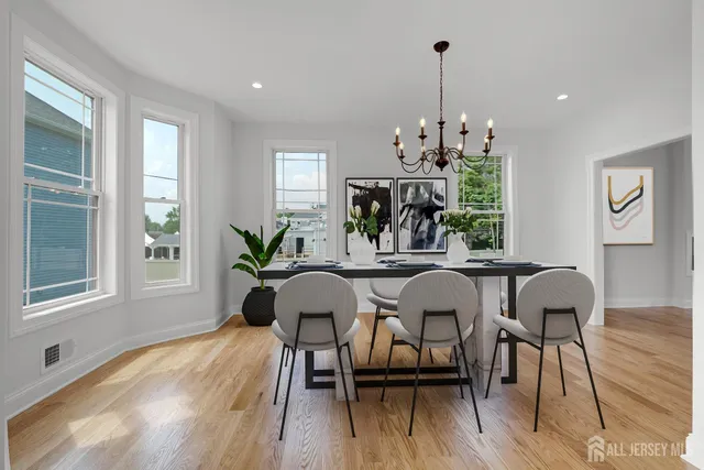 a kitchen with stainless steel appliances a stove a sink a center island and a window