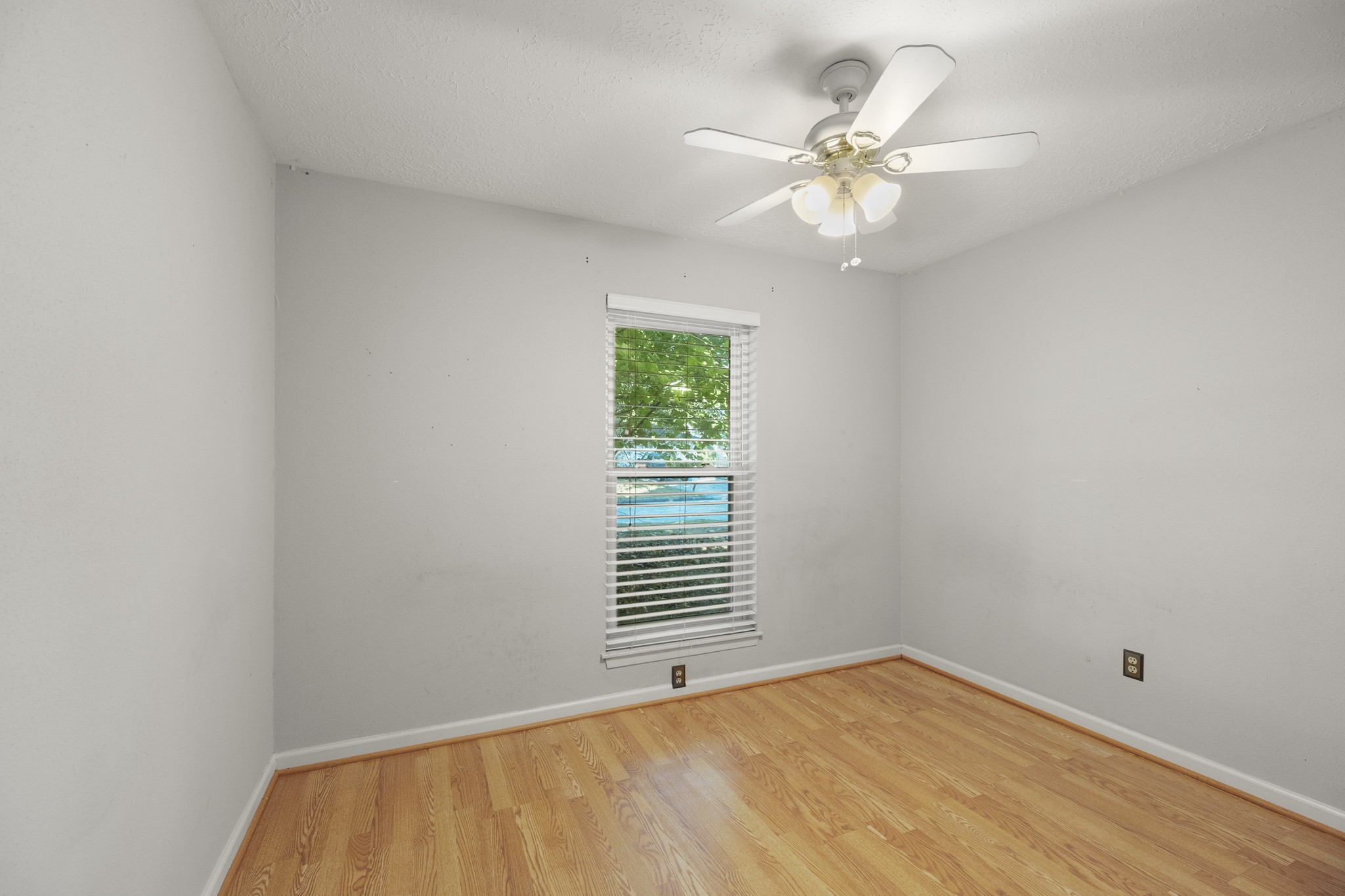23826 Lestergate Drive Spring, TX 77373 - Photo 21 of 45 Turning into the second bedroom on the left, a single window brings in natural light and gives the room a pleasant focal point, while a ceiling fan sits overhead.