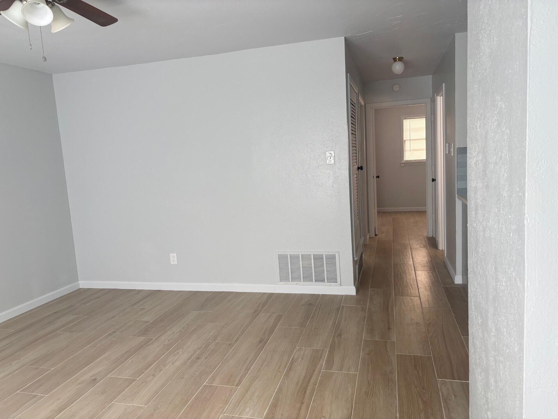 2409 45th Street, Unit 8 Lubbock, TX 79412 - Photo 4 of 8 a view of a room with wooden floor