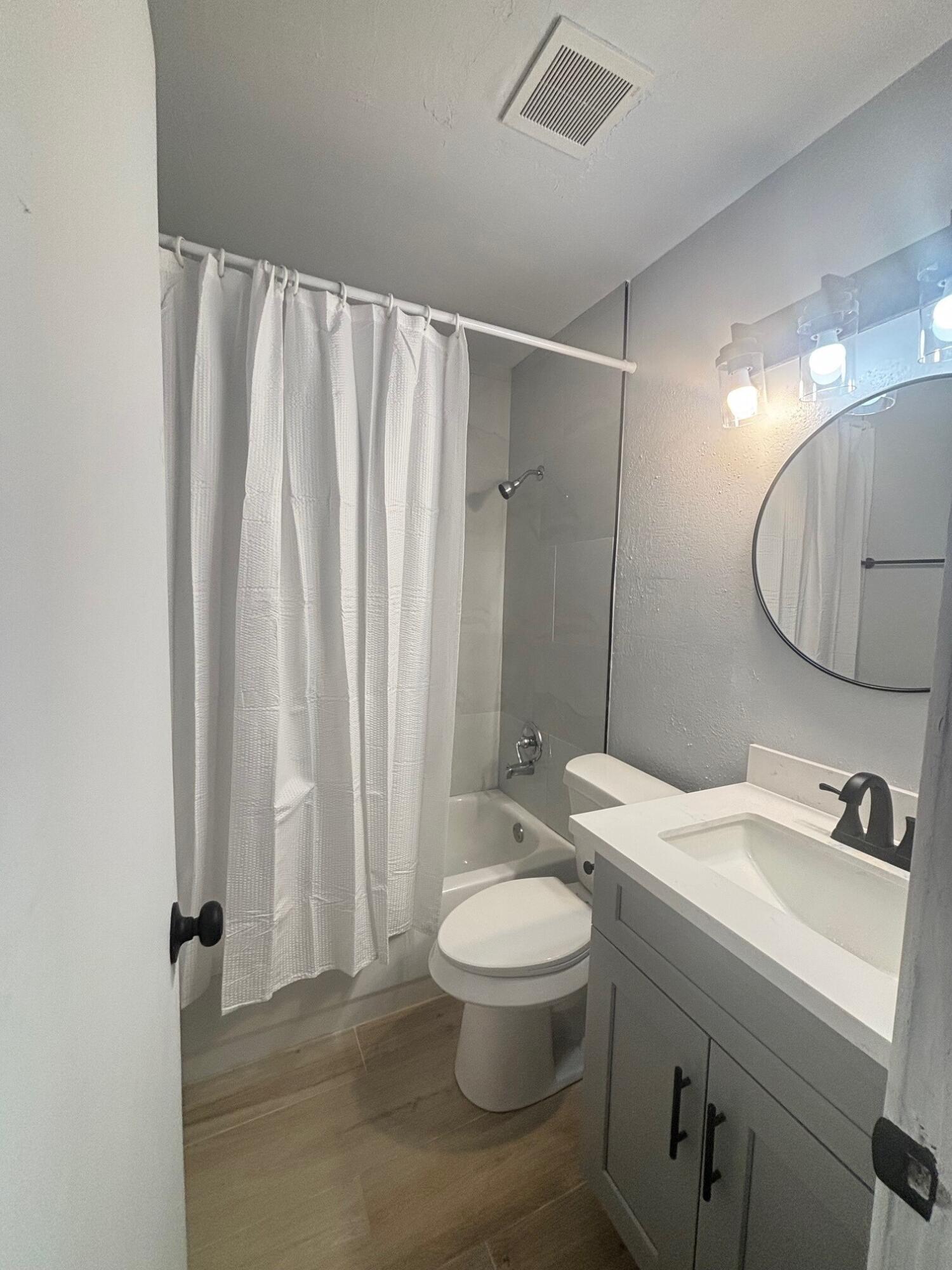 2409 45th Street, Unit 8 Lubbock, TX 79412 - Photo 5 of 8 a bathroom with a sink a toilet and shower