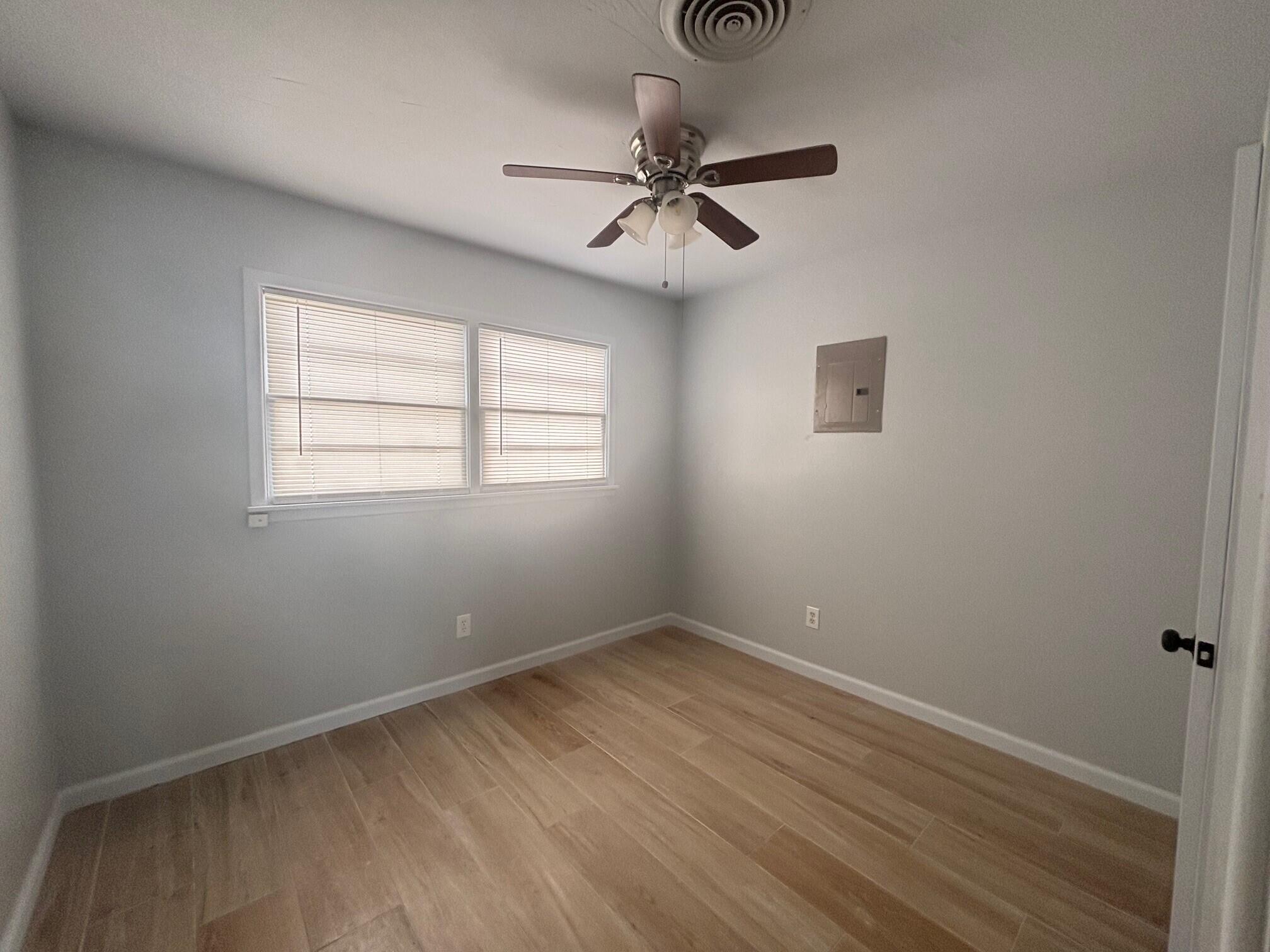 2409 45th Street, Unit 8 Lubbock, TX 79412 - Photo 6 of 8 an empty room with a window and a fan