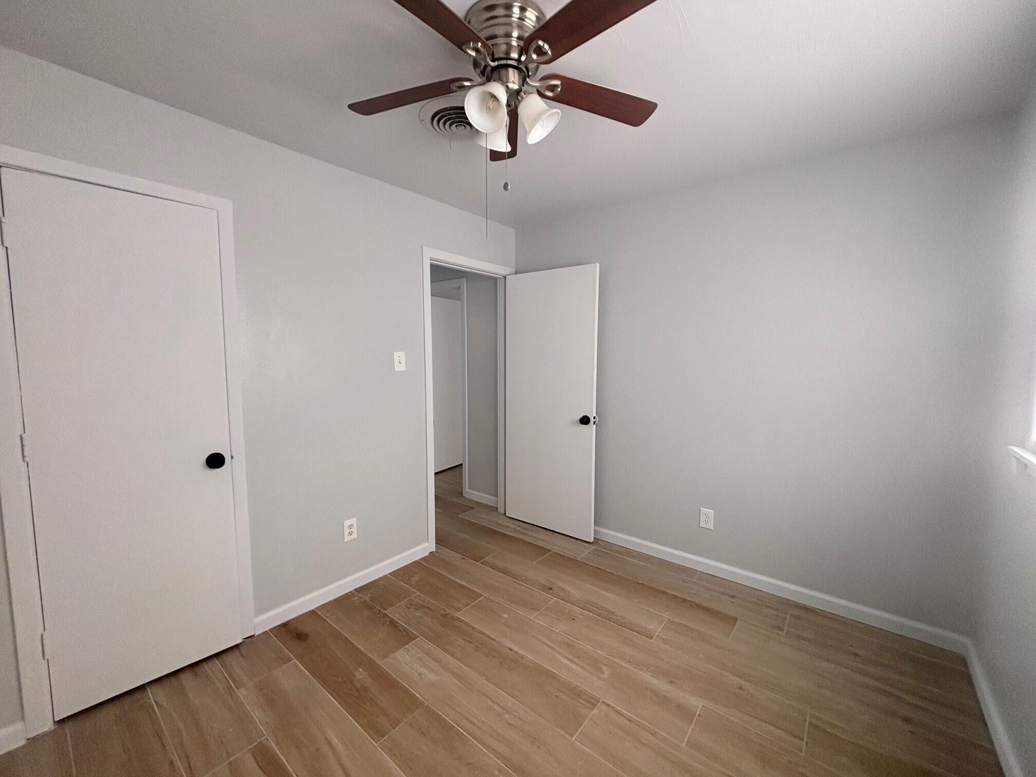 2409 45th Street, Unit 8 Lubbock, TX 79412 - Photo 7 of 8 wooden floor in an empty room
