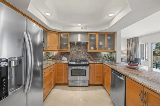 a kitchen with stainless steel appliances granite countertop a stove and a refrigerator
