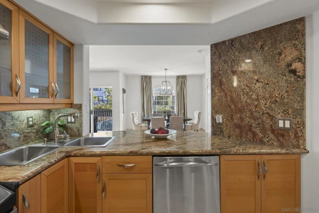 a kitchen with granite countertop a sink and a window