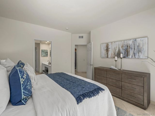 a bedroom with a bed and a dresser