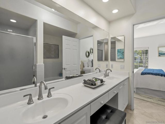 a bathroom with a sink double vanity and a mirror