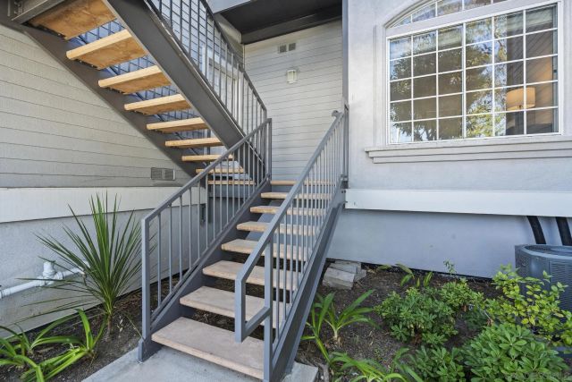 a front view of a house with a garden and garage