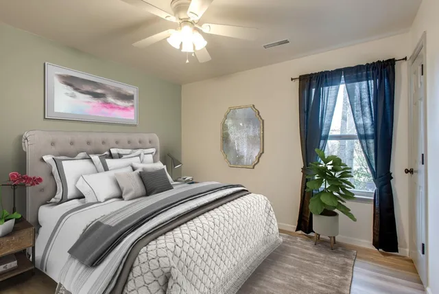 a bedroom with bed and a window