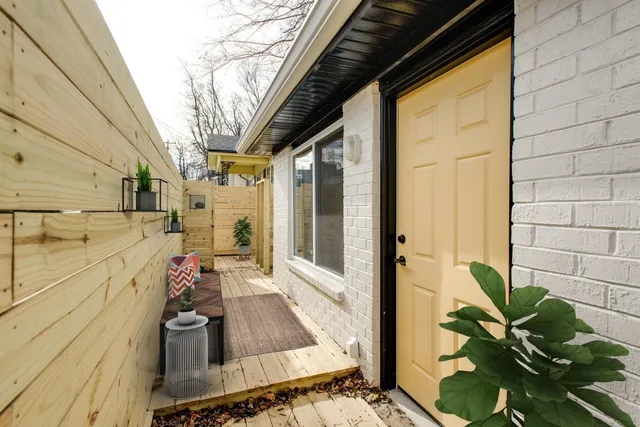 a view of a balcony with wooden floor and furniture