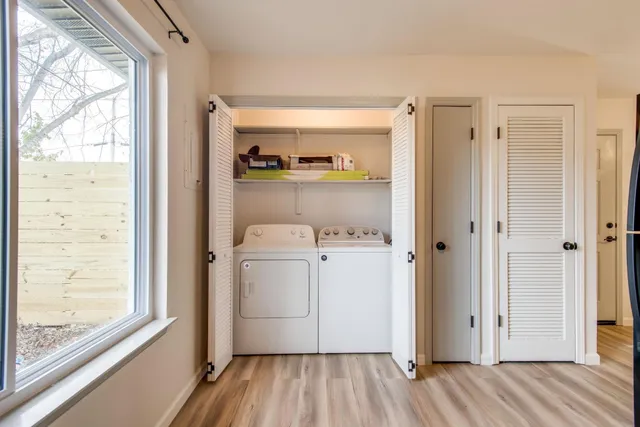 a view of washer and dryer with wooden floor