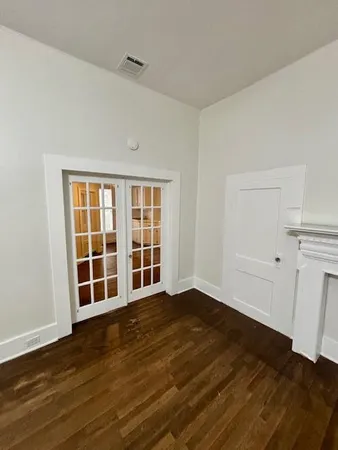 a view of wooden floor and windows in a room