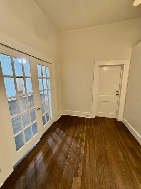 210 East Phillips Street Conroe, TX 77301 - Photo 14 of 27 a view of an empty room with wooden floor and a window