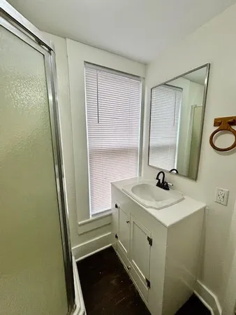 a view of empty room with wooden floor