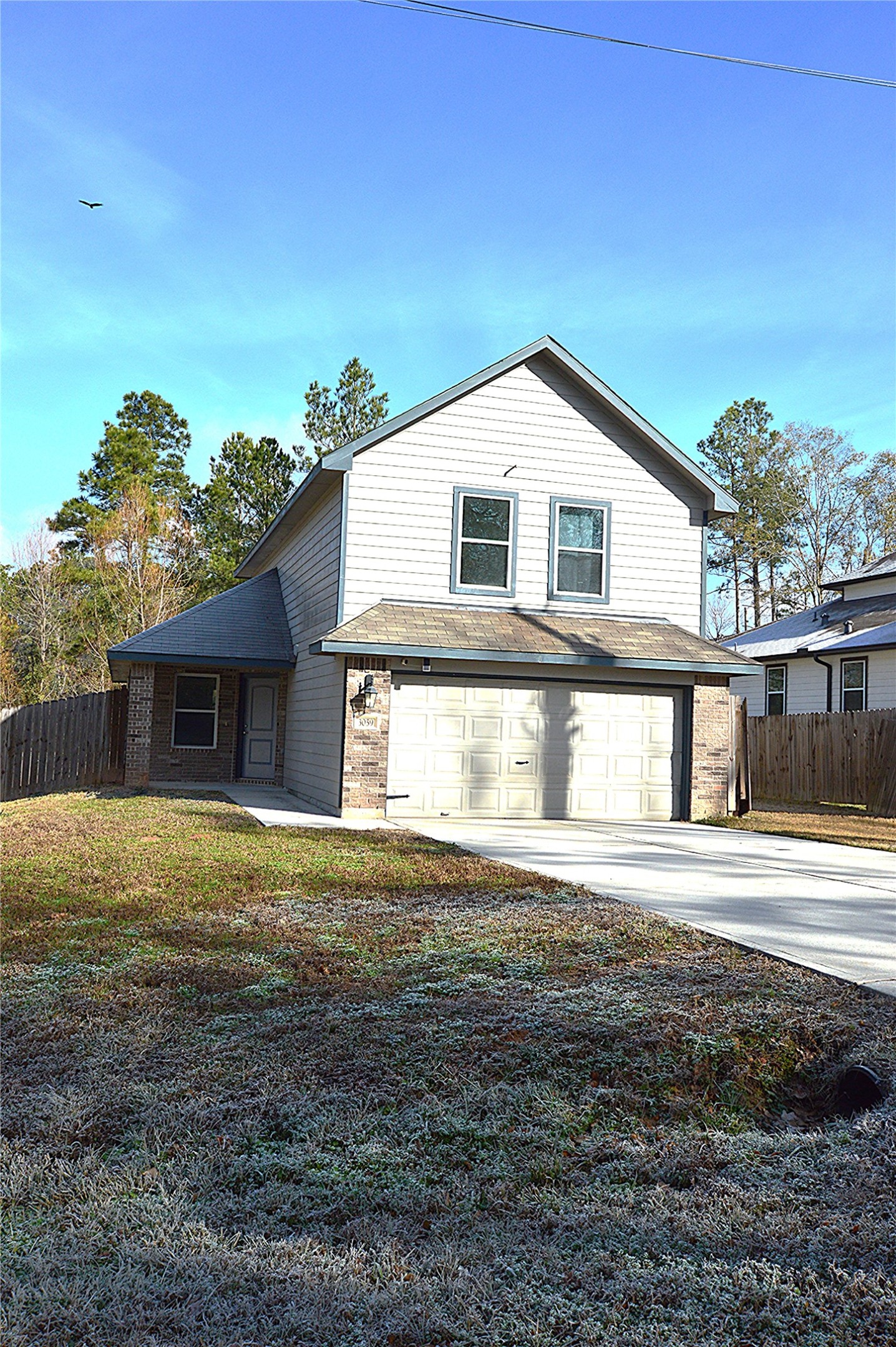 3059 Caddo Willis, TX 77378 - Photo 1 of 27 a front view of a house with a yard