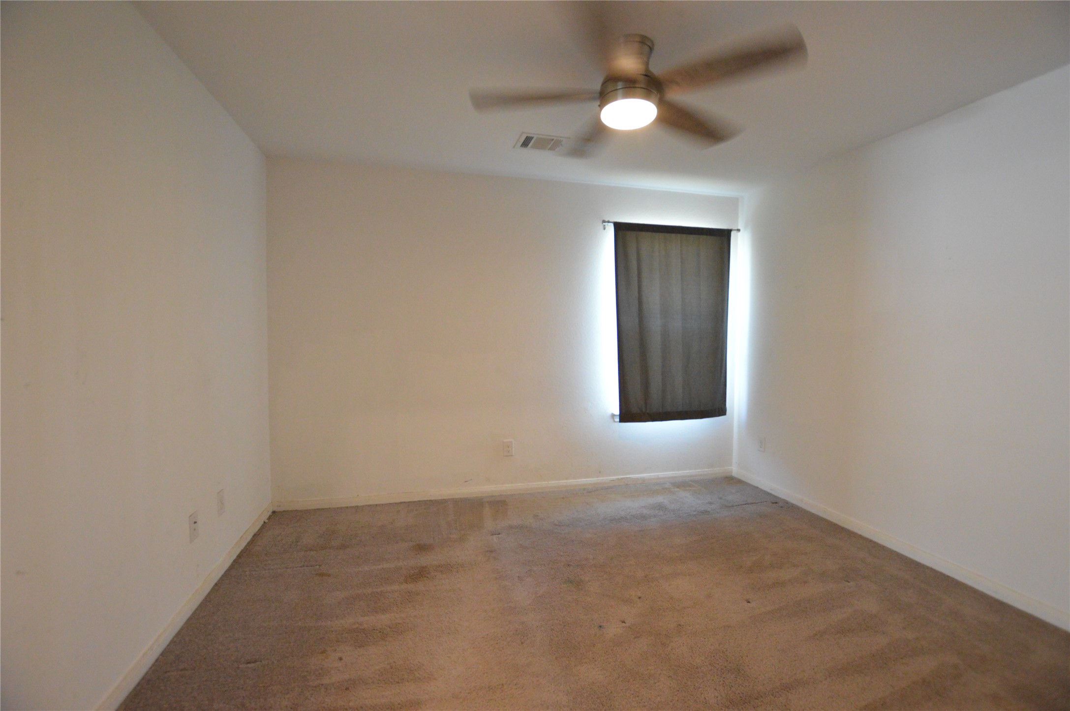 3059 Caddo Willis, TX 77378 - Photo 12 of 27 an empty room with a fan & a window