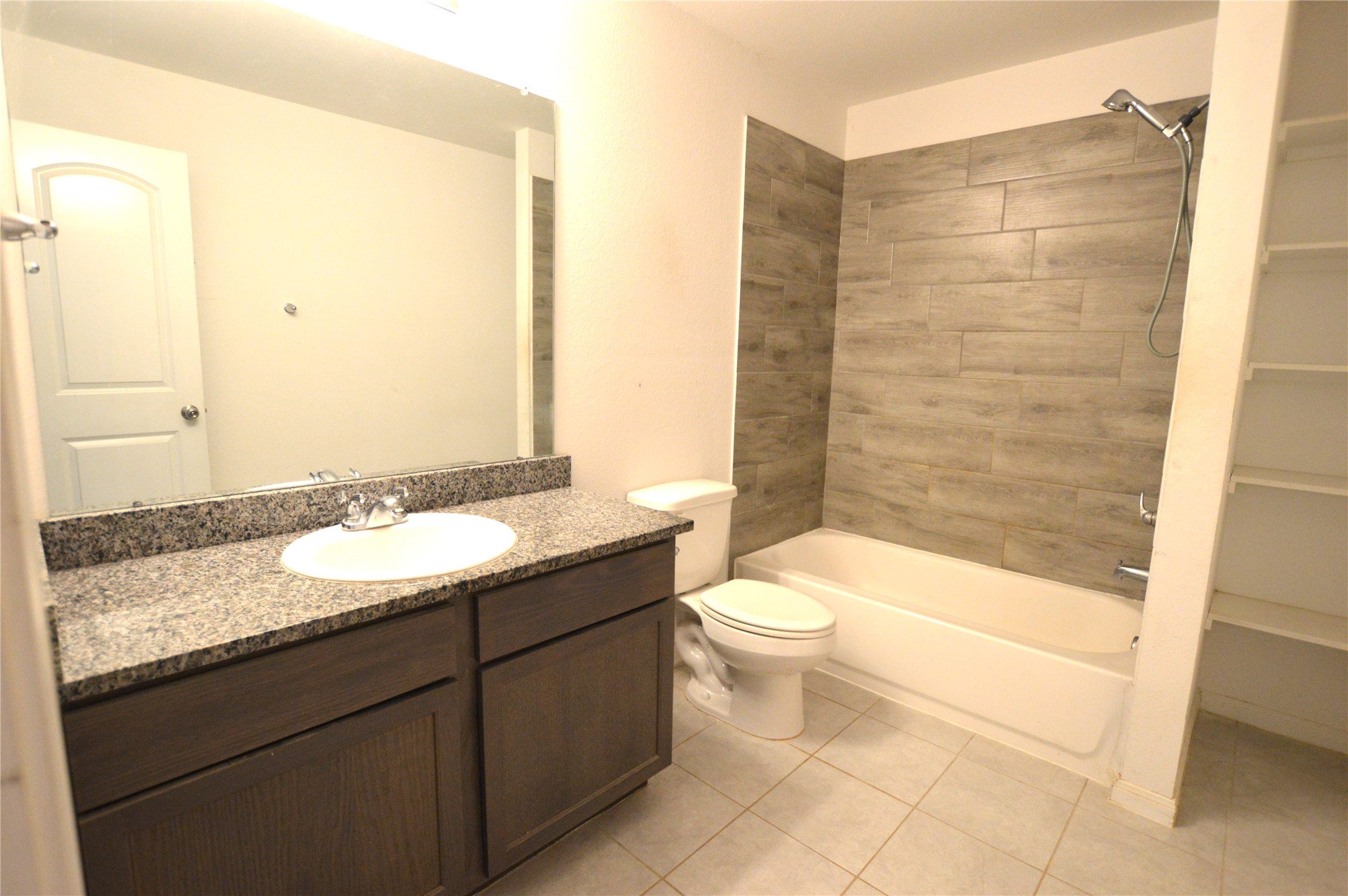 3059 Caddo Willis, TX 77378 - Photo 13 of 27 a bathroom with a granite countertop sink toilet and shower
