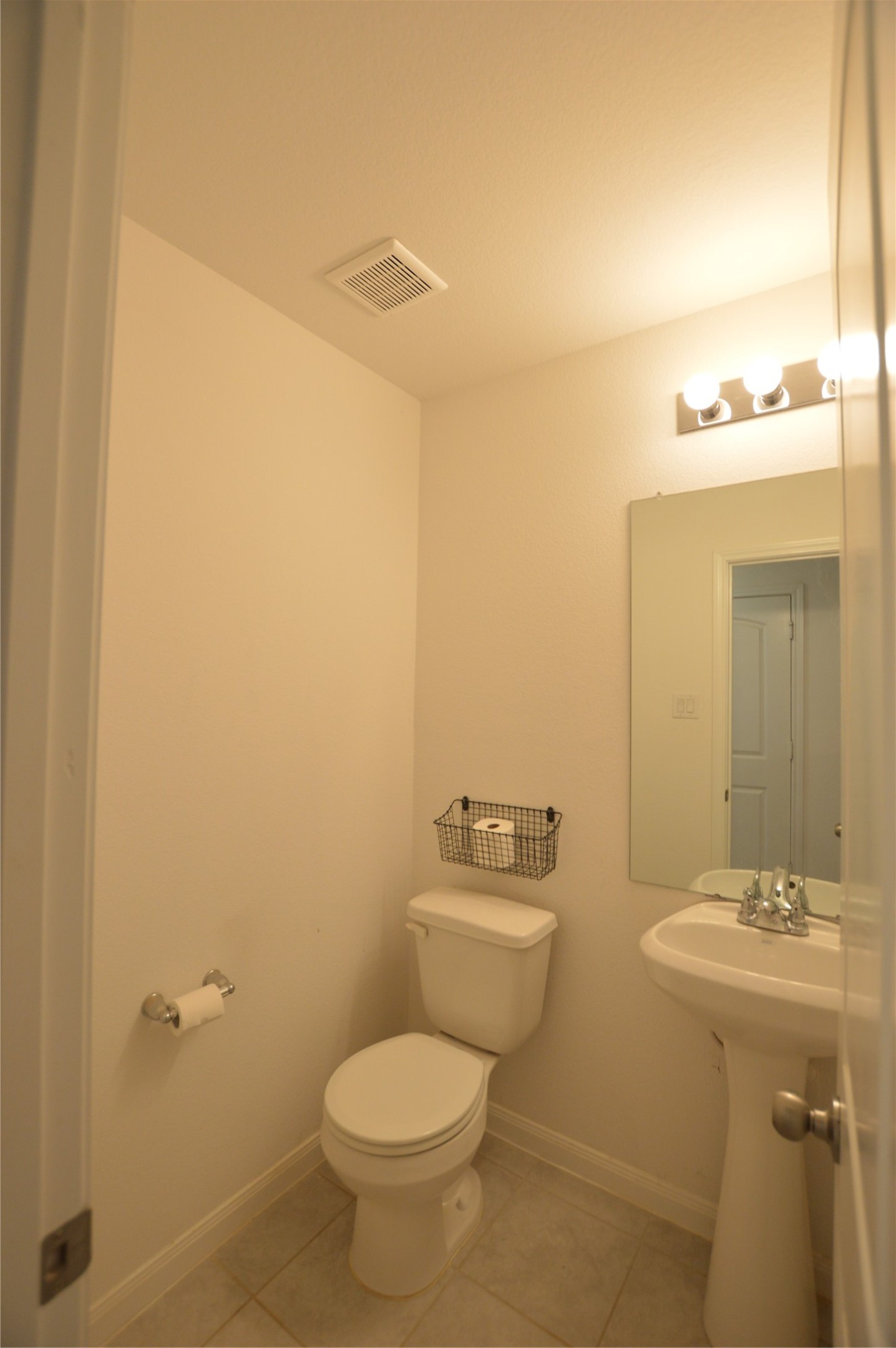 3059 Caddo Willis, TX 77378 - Photo 23 of 27 a bathroom with a sink and mirror with toilet