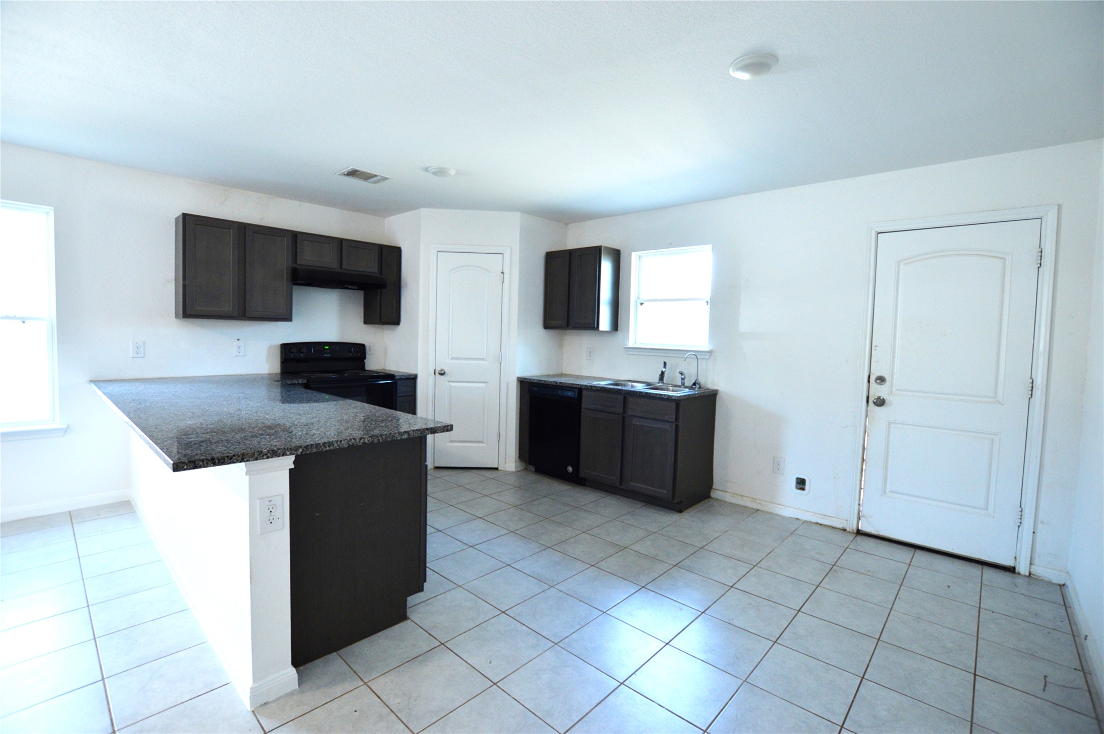 3059 Caddo Willis, TX 77378 - Photo 6 of 27 a kitchen with stainless steel appliances a sink and a microwave