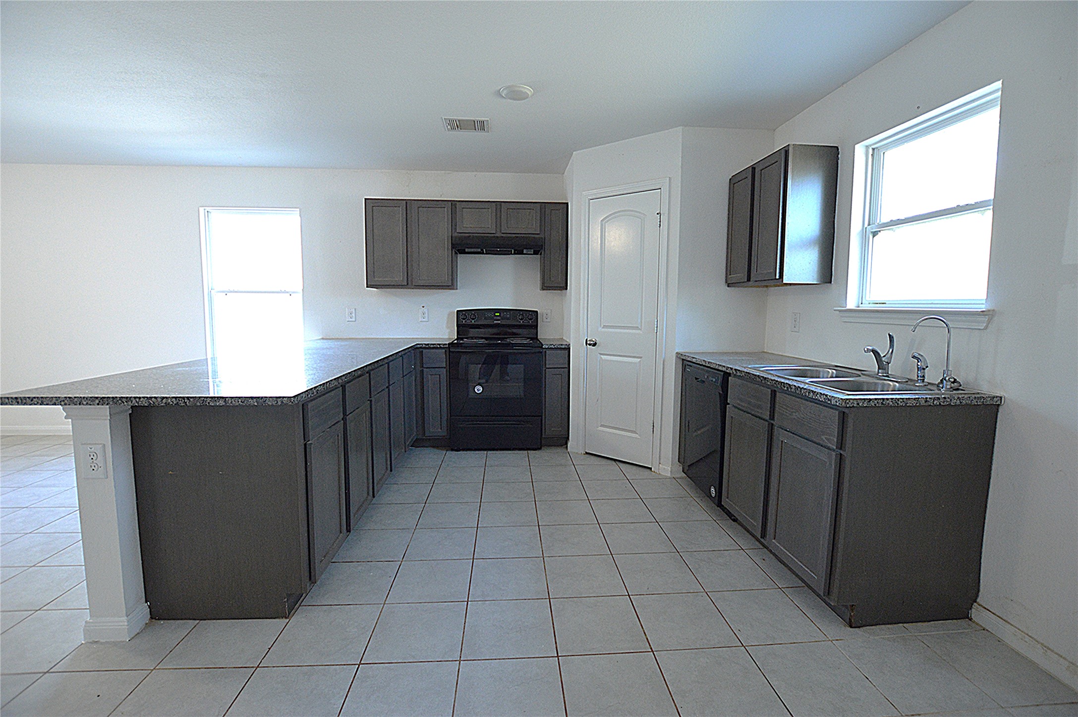 3059 Caddo Willis, TX 77378 - Photo 7 of 27 a kitchen with stainless steel appliances granite countertop a refrigerator and a stove
