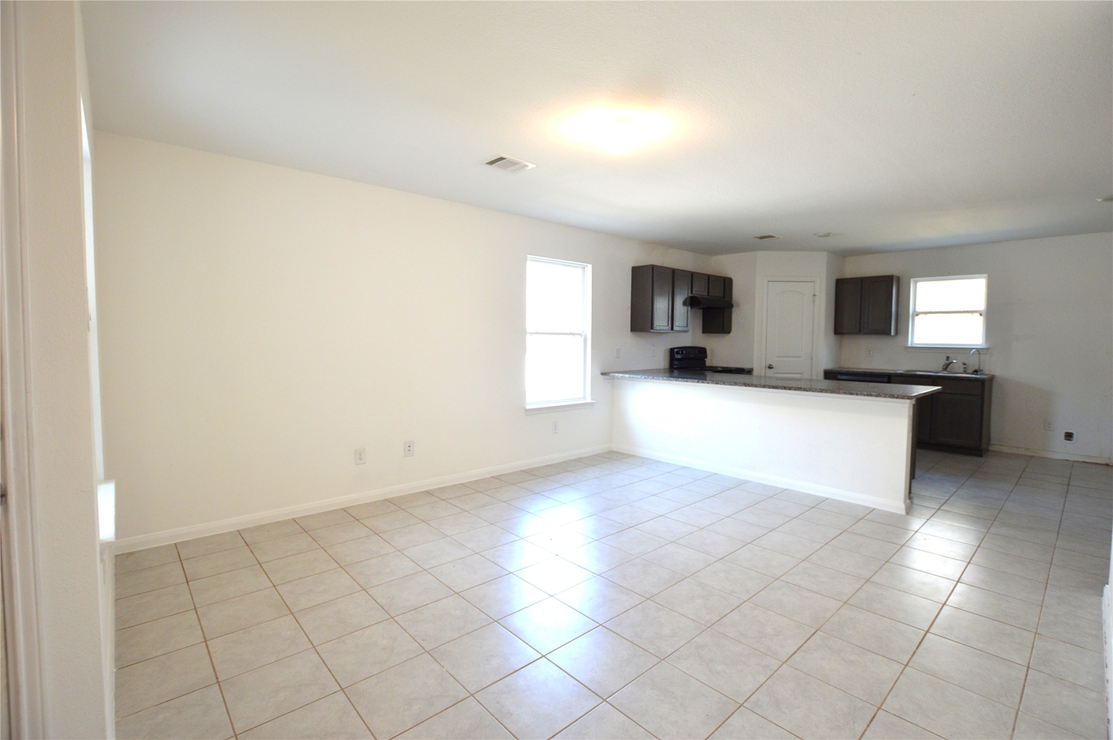 3059 Caddo Willis, TX 77378 - Photo 10 of 27 a large white kitchen with a sink and cabinets