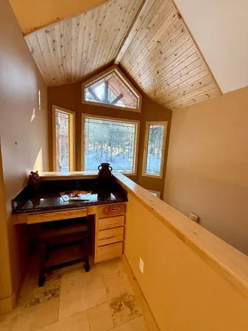 a spacious bedroom with a bed and wooden floor