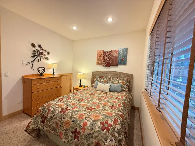 a spacious bedroom with a bed and a couch