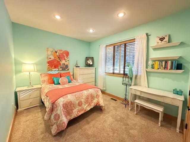 a bathroom with a granite countertop sink a large mirror and a bathtub