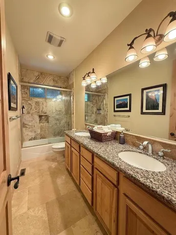 a living room with furniture a rug and a book shelf