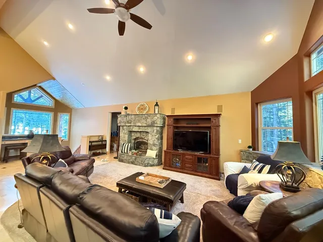 a large kitchen with stainless steel appliances kitchen island granite countertop a refrigerator and a sink