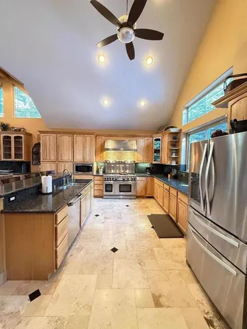 a living room with furniture and a floor to ceiling window