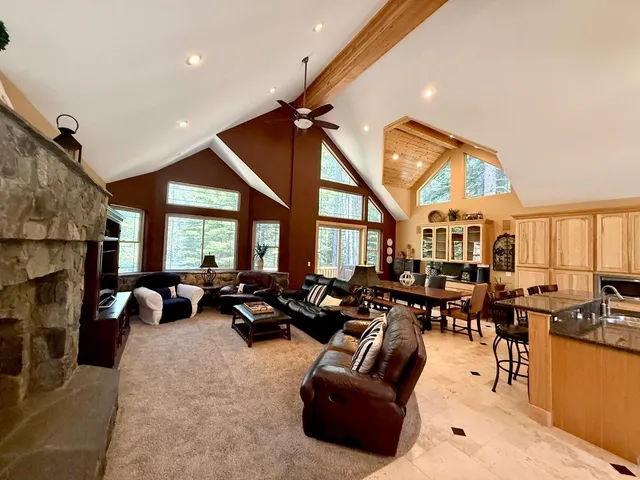 a kitchen with stainless steel appliances granite countertop sink stove and refrigerator