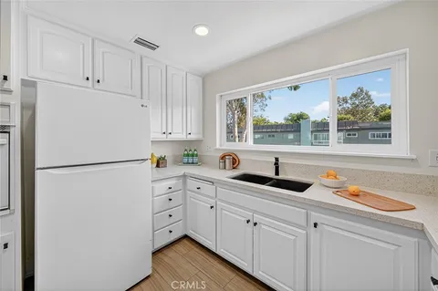 a white refrigerator freezer sitting inside of a kitchen