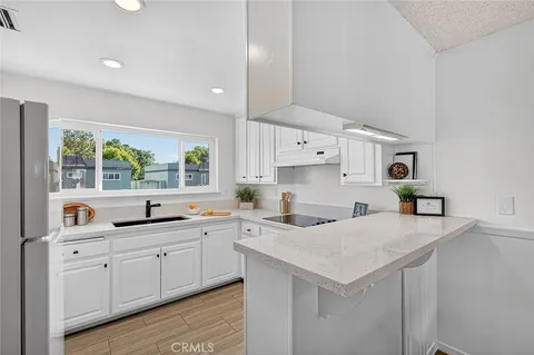 a kitchen with a sink a stove and cabinets