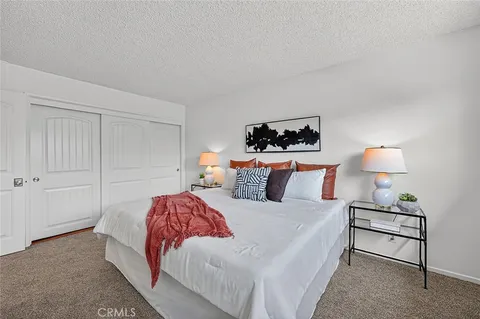 a bedroom with a bed and a lamp on table