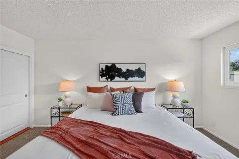 a bedroom with a bed and a lamp on table