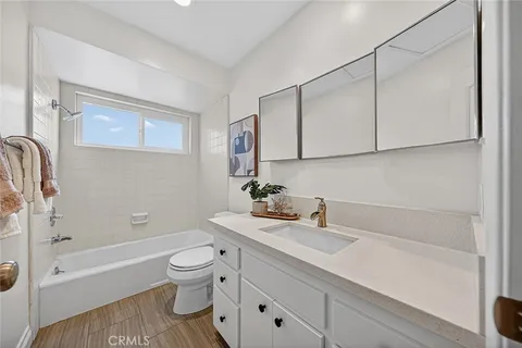 a bathroom with a sink a toilet and a bathtub
