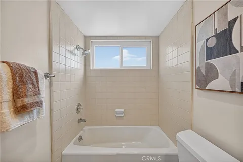 a bath tub sitting next to a white toilet