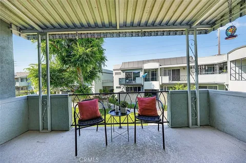 a view of an chairs and table in the balcony