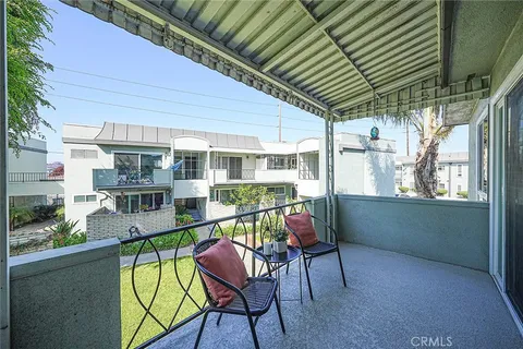 a view of a house with swimming pool and sitting area