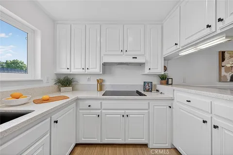 a kitchen with white cabinets and a sink