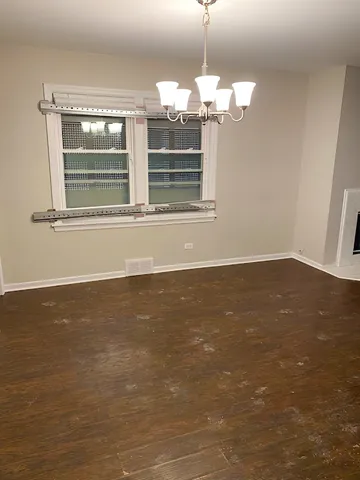 a view of wooden floor and windows in a room