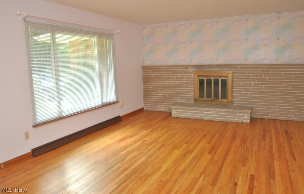 3271 Edington Road Akron, OH 44333 - Photo 2 of 20 Formal living rm has lovely wood floors, wood burning fireplace with brick wall & hearth and large picture window.