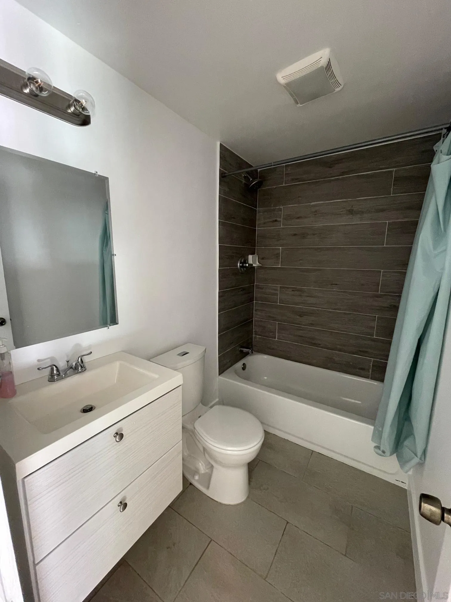 8632 Eileen Street Spring Valley, CA 91977 - Photo 7 of 12 a bathroom with a sink a toilet and shower