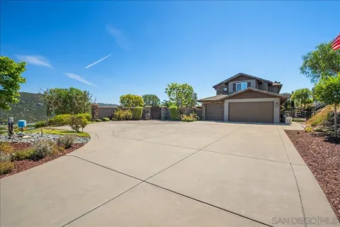 a view of a house with swimming pool and sitting area