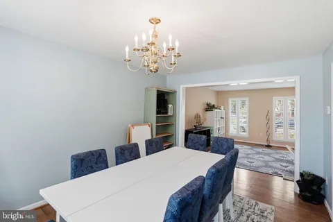 a view of a livingroom with wooden floor and a chandelier