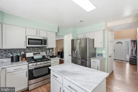 a kitchen with a refrigerator stove and microwave