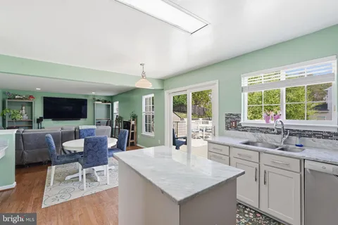 a kitchen with a sink and living room