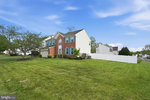 a front view of house with yard and trees